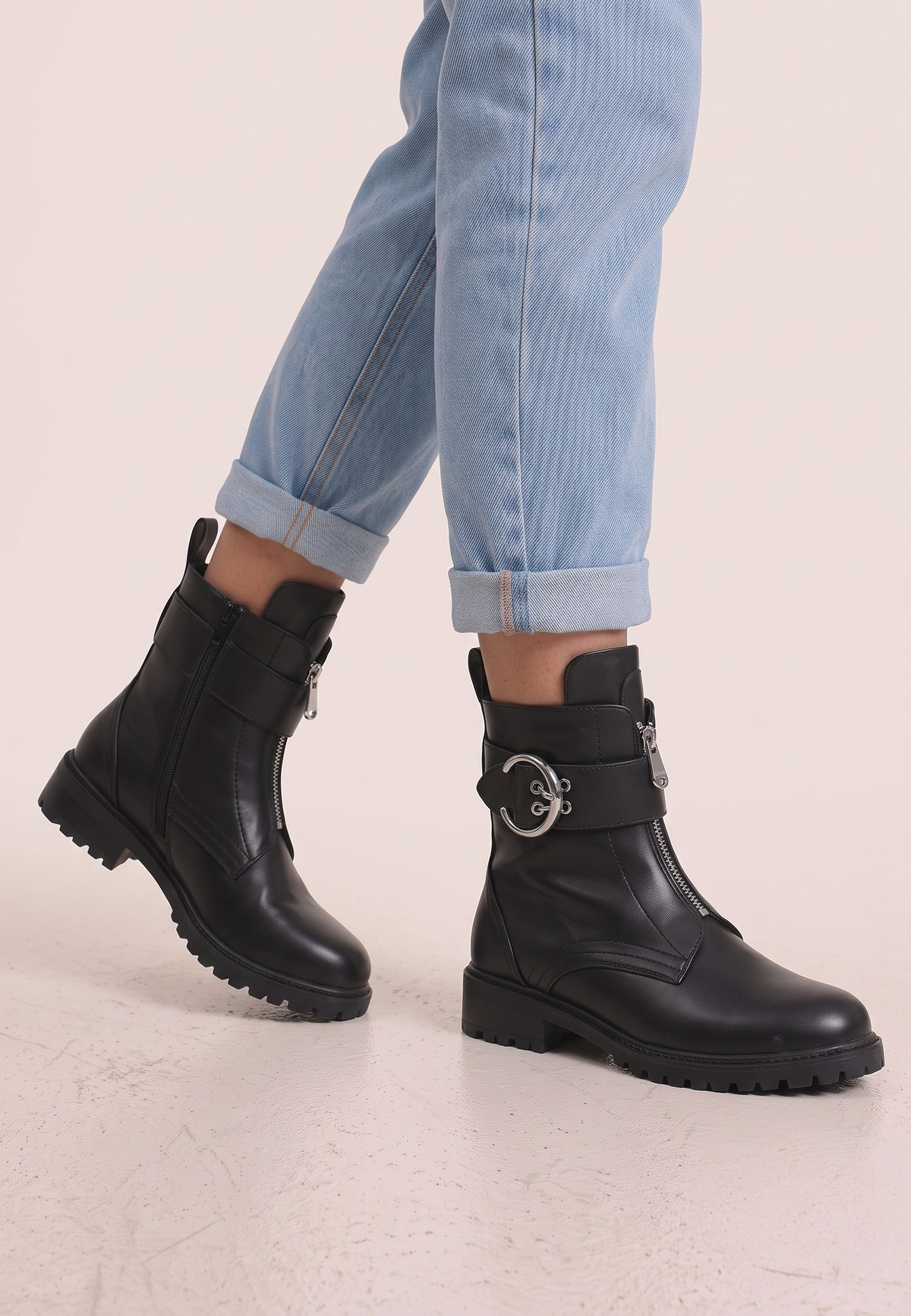 Falio black leather ankle boots with front zipper and silver buckle detail worn with cuffed light blue jeans