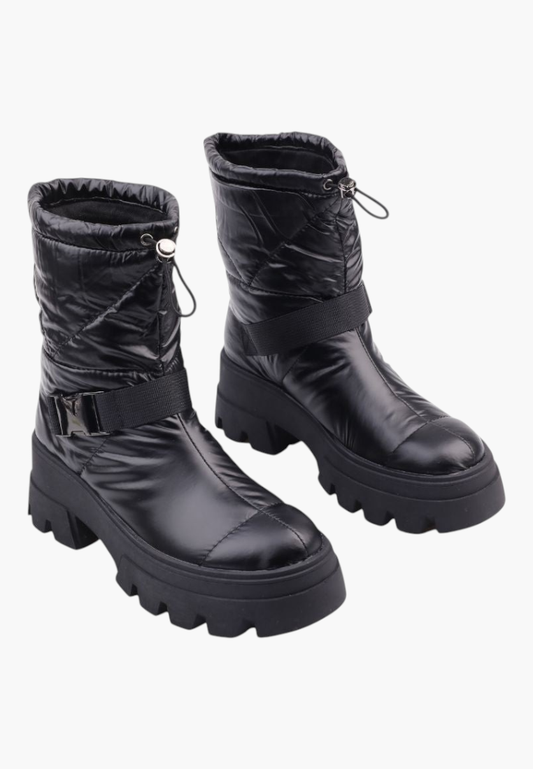 Falio black quilted textile ankle snow boots with thick lug soles, decorative strap, and adjustable drawstring top.