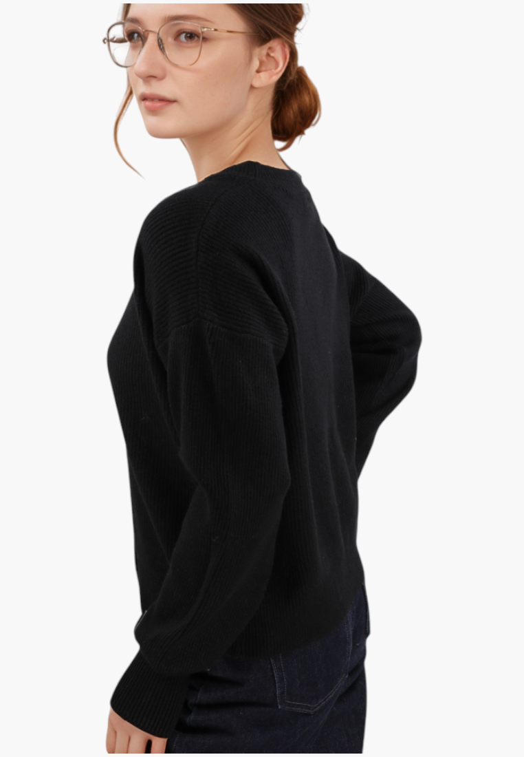 Falio black ribbed knit cardigan with long sleeves worn by a woman in glasses, side view