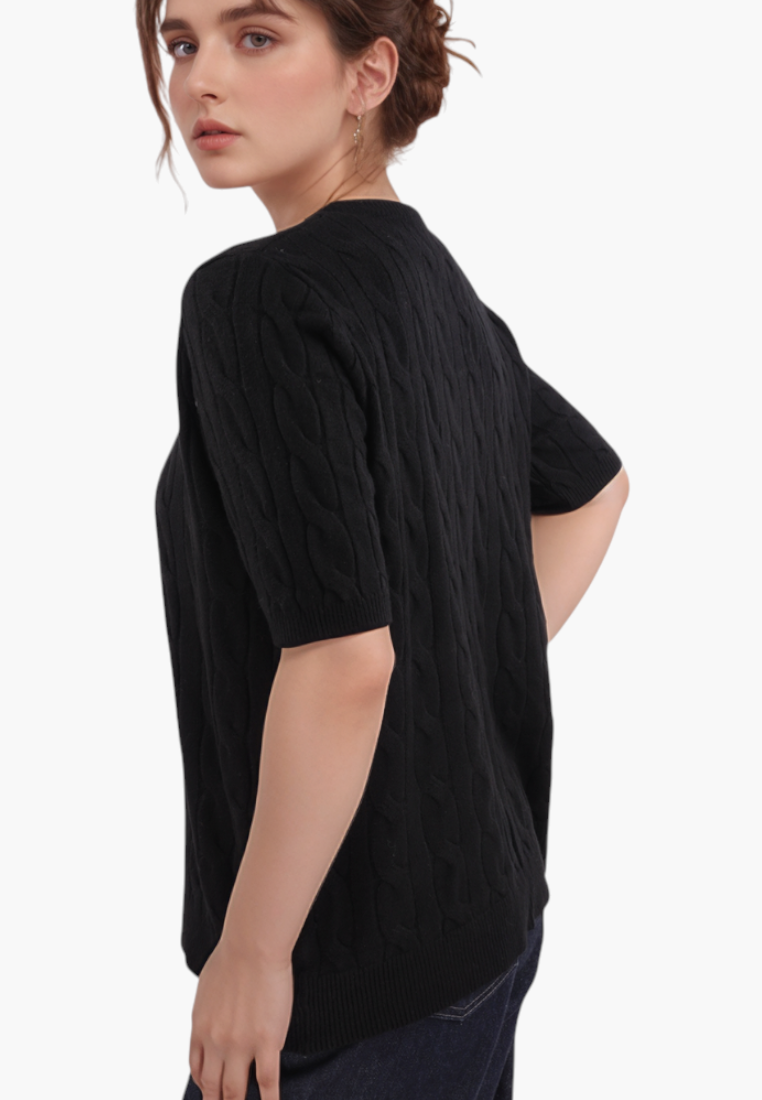 Falio black short-sleeve cable knit sweater with a round neckline worn by a woman, side view