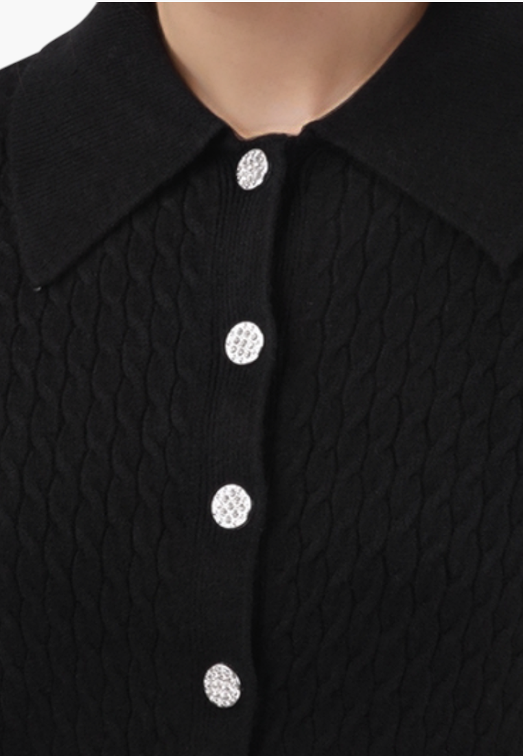 Falio black sleeveless knit sweater with a collared neckline and decorative silver buttons in a cable knit texture.