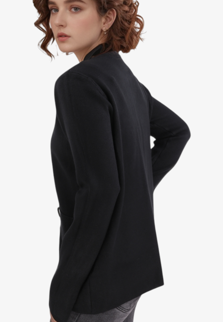Falio black viscose sweater with long sleeves and pockets worn by a woman, side view against a white background.