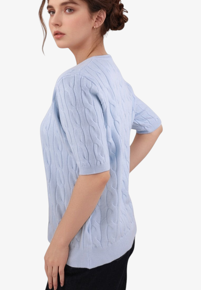 Falio light blue short-sleeve cable knit sweater with a round neckline worn by a woman, side view