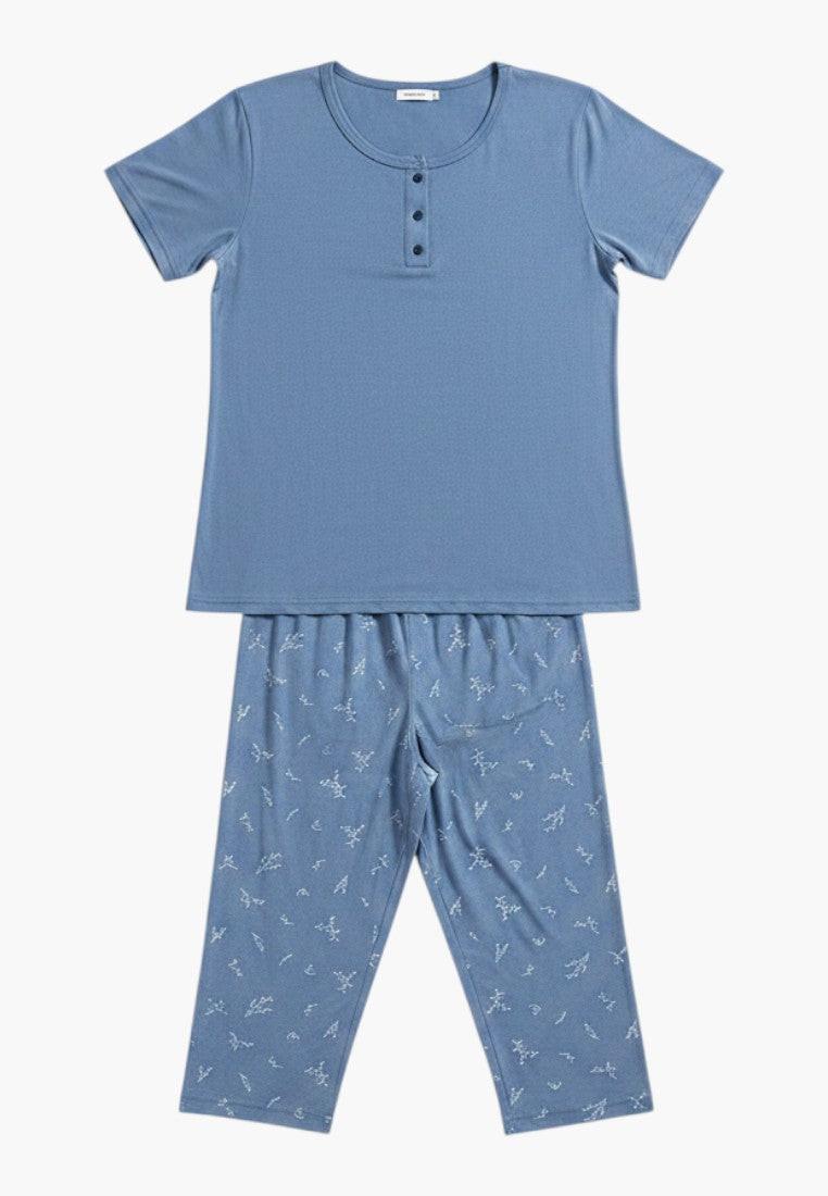 Falio blue 100% cotton plus size women's pajama set with short sleeves and 3/4 length pants featuring a subtle all-over print and button-up neckline.