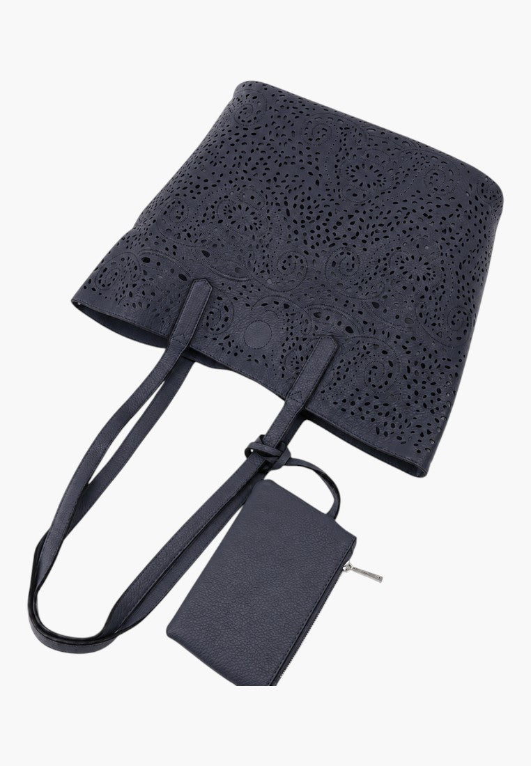 Falio shopper bag in dark blue faux leather with intricate laser-cut floral patterns and a matching small pouch.