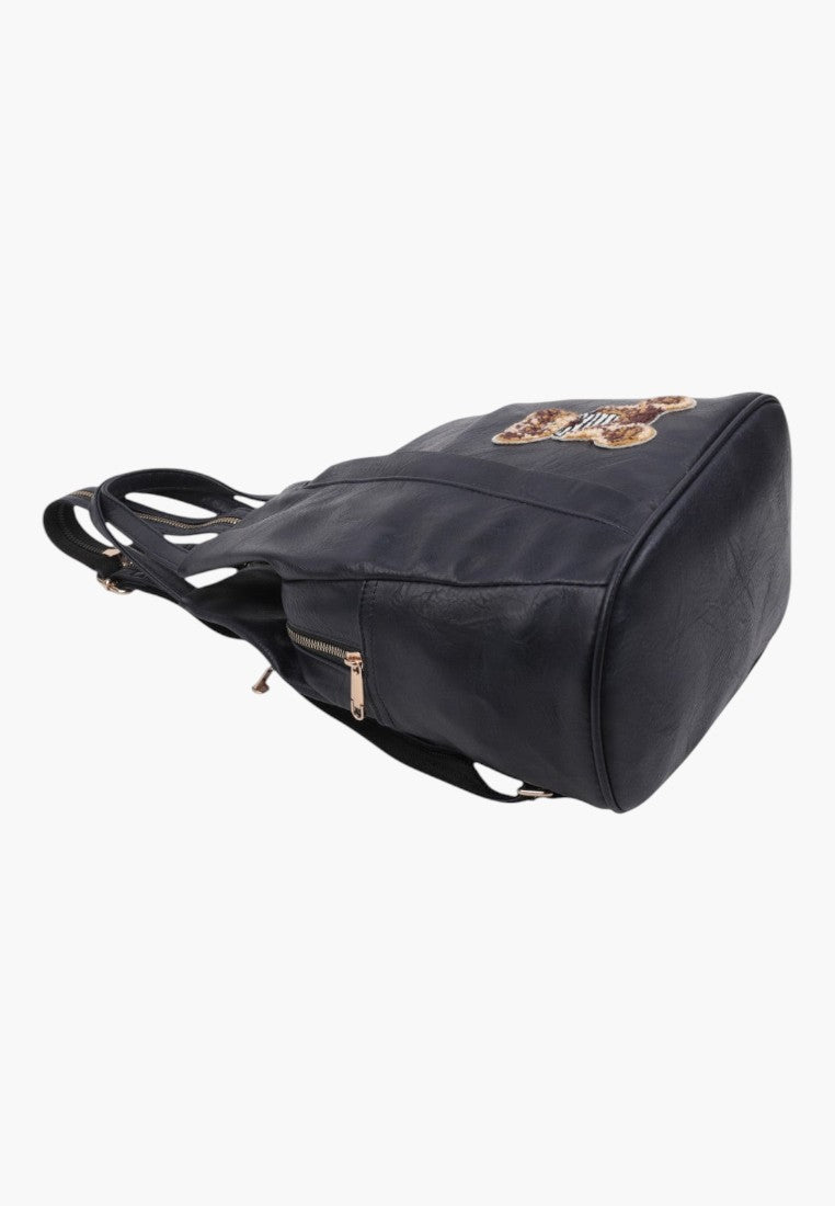 Falio small blue faux leather urban backpack with zipper closure and decorative patch, side view