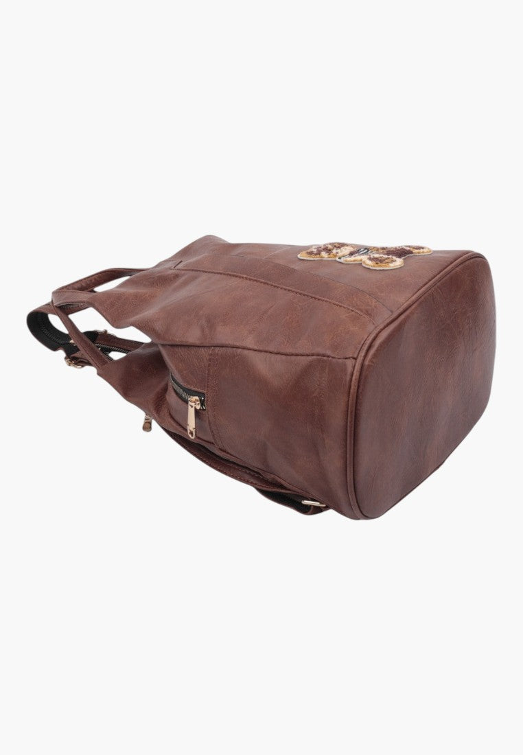 Falio small brown urban backpack made of eco-leather with a decorative butterfly patch and side zipper pocket