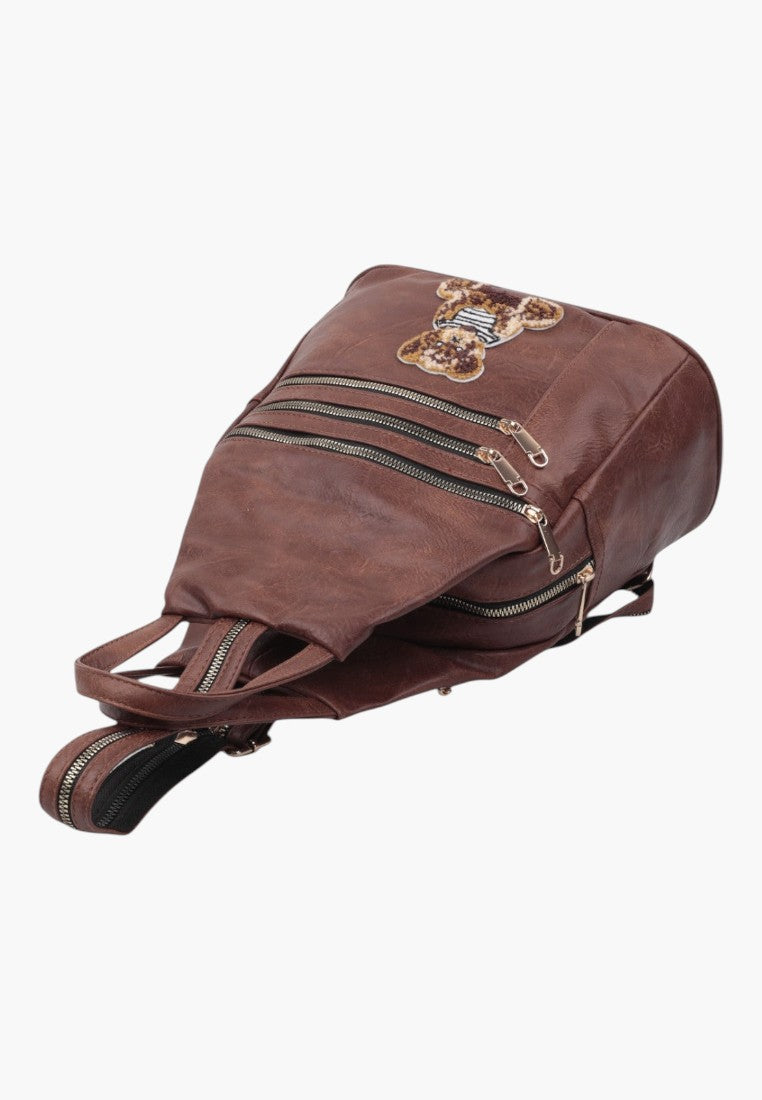 Falio small brown faux leather city backpack for women with a cute bear patch and multiple zippered pockets
