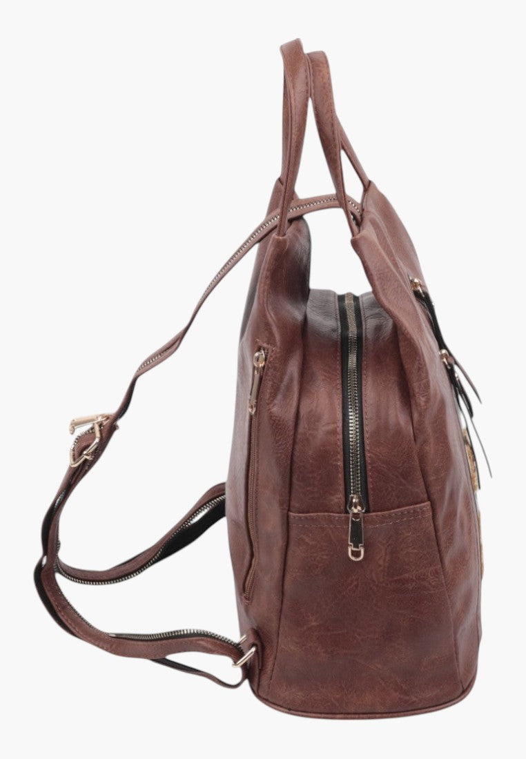 Falio brown faux leather city backpack with side zipper pockets and adjustable straps, side view