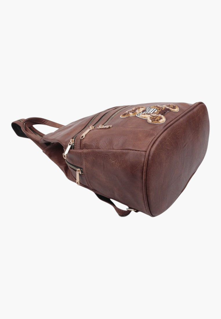 Falio small brown faux leather city backpack with multiple zippered pockets and decorative bear patch