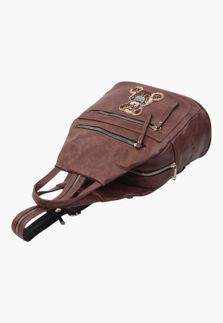 Falio brown faux leather urban backpack with a cute teddy bear patch and multiple zippered pockets
