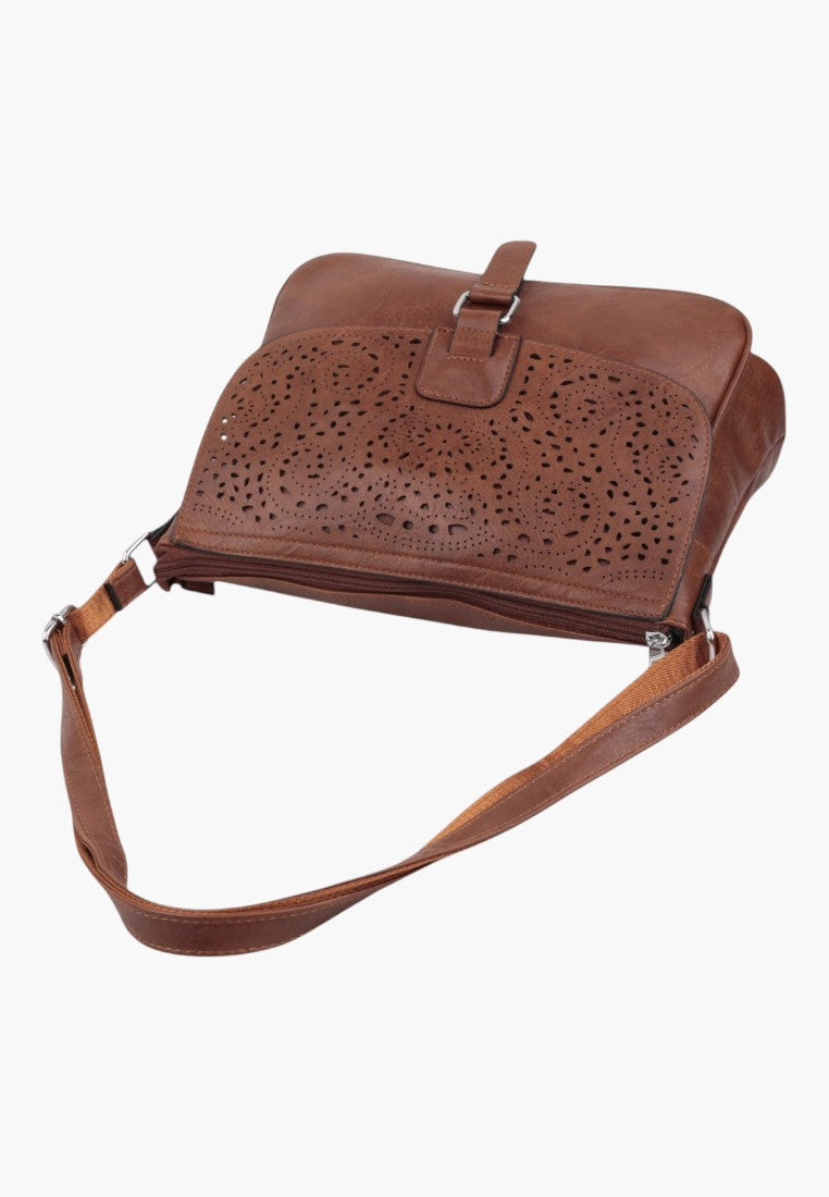 Falio brown leather crossbody bag with intricate laser-cut floral patterns and an adjustable shoulder strap