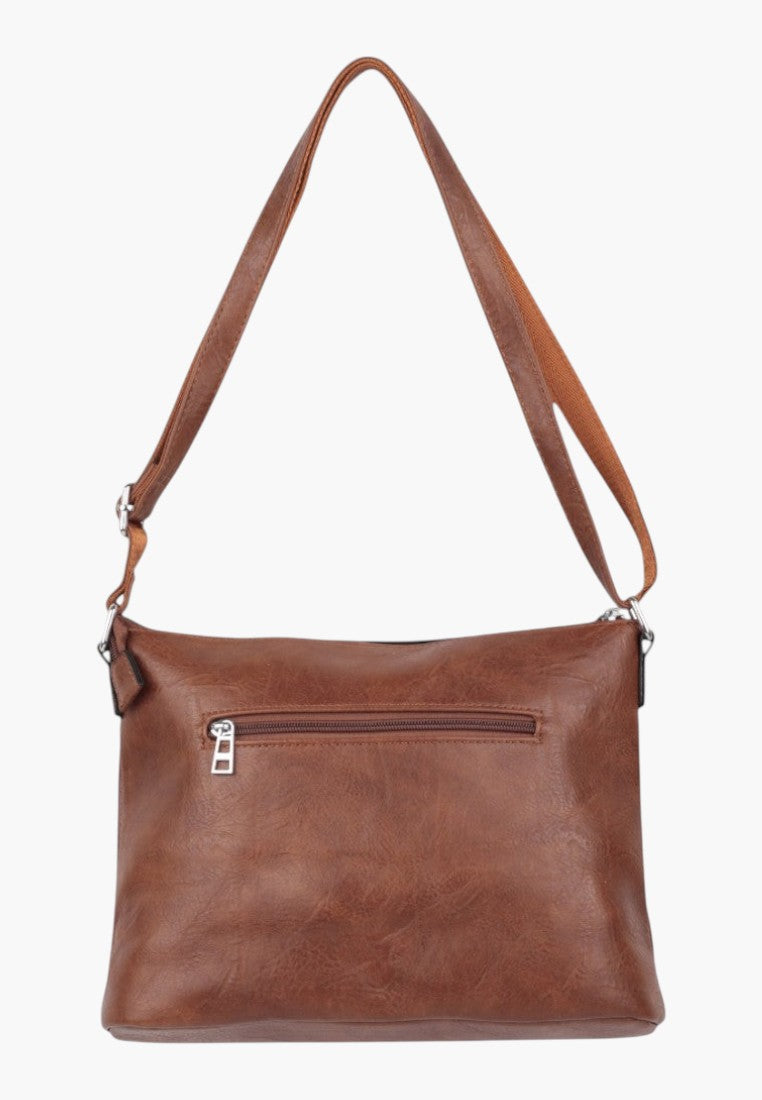 Falio brown faux leather crossbody bag with an adjustable strap and a rear zippered pocket for daily essentials.