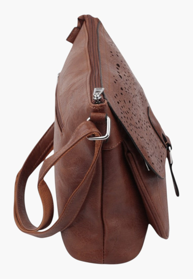 Falio brown crossbody bag with a laser-cut perforated flap and silver hardware, side view