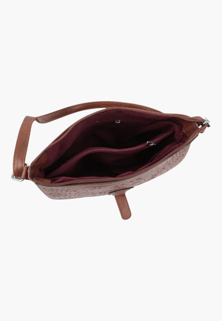 Falio brown crossbody bag with a textured finish and zippered interior compartment shown from an overhead view