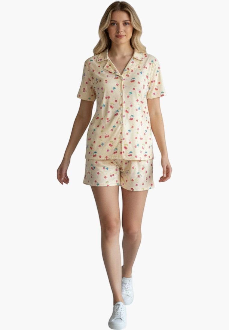 Falio women's short pajama set in cream with a red cherry print. Features a collared, button-up top and short bottoms, made of 100% cotton.