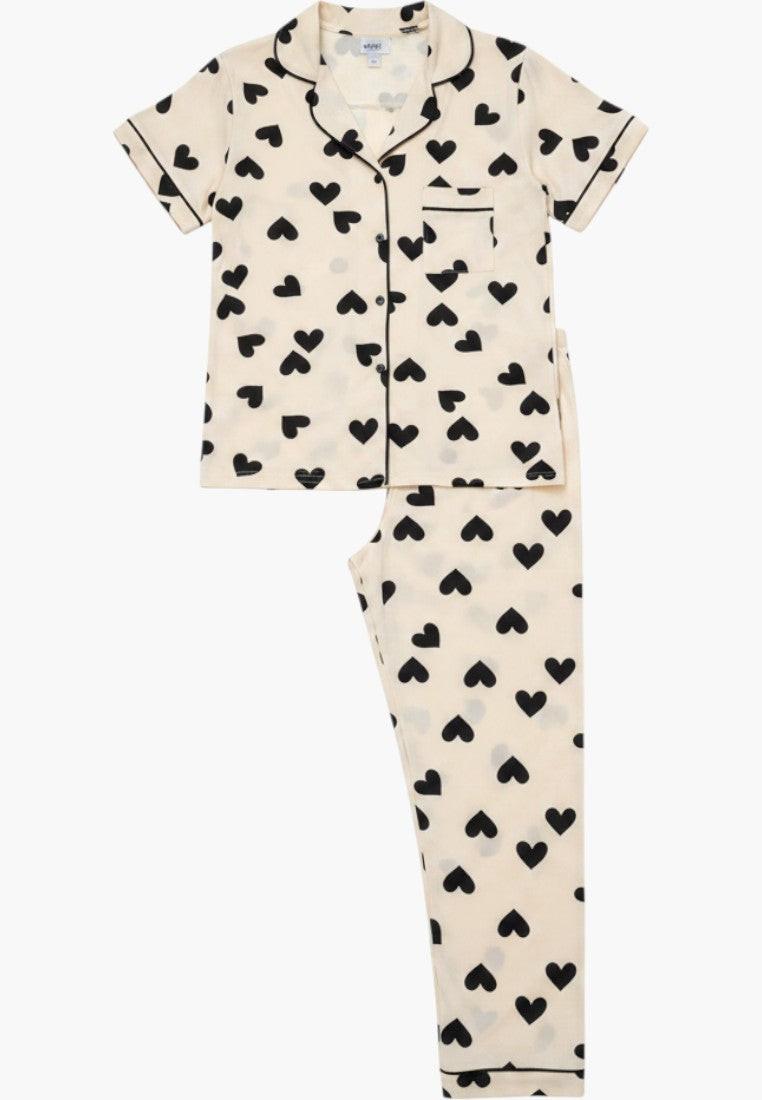 Falio cream cotton pajama set with black hearts, short sleeves, button-up top, and long pants.