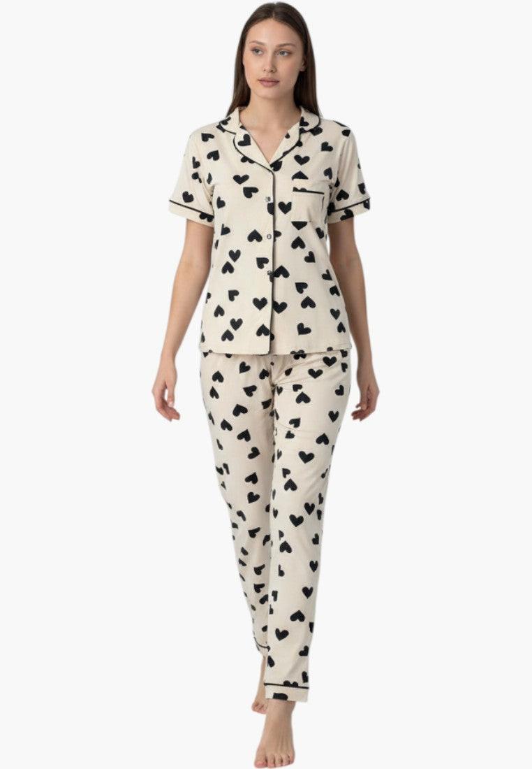 Falio cream 100% cotton pajama set with black hearts, short sleeves, and long pants. Features a notched collar and button-down top.