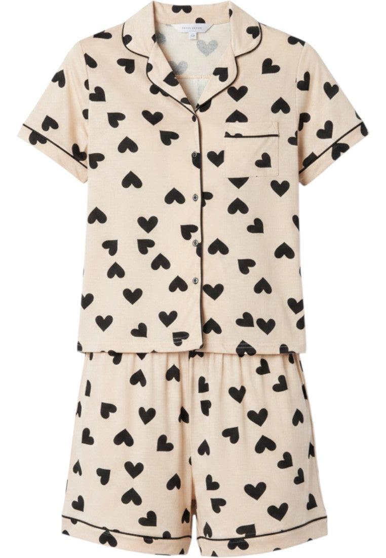 Falio women's short sleeve pajama set in cream with black heart print and black trim. Button-up top and shorts.
