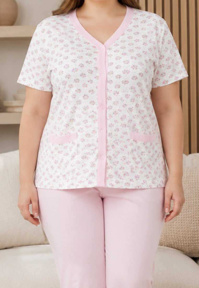 Falio women's 100% cotton pajama set with a floral button-down top and pink capri pants in a cozy living room.