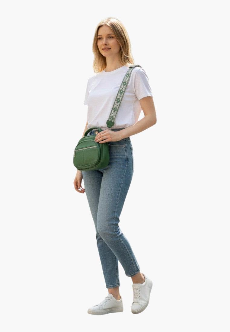 Falio green crossbody bag made of eco-leather with a patterned strap, worn by a woman in jeans and a white t-shirt.