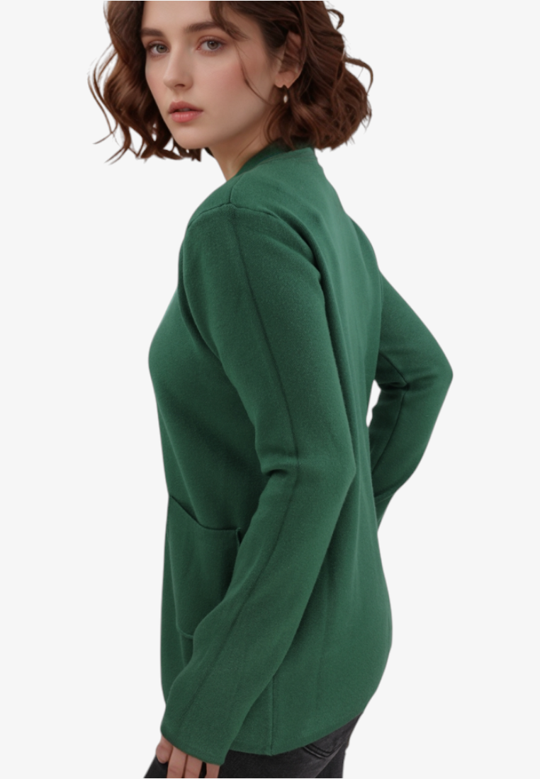 Falio plus size green viscose sweater with long sleeves and pockets worn by a woman in a side profile view