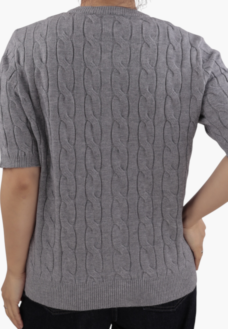 Falio grey cable knit sweater with short sleeves and a round neckline worn by a woman