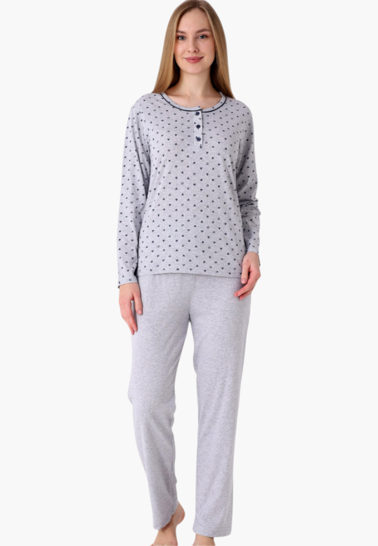 Model wearing a Falio long-sleeve cotton pajama set with a grey heart print top and solid grey trousers.