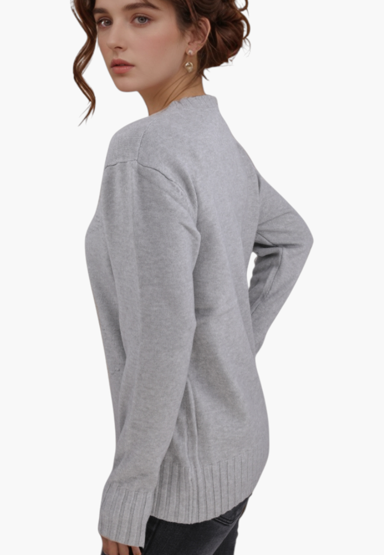 Model wearing a grey Falio crew neck sweater made from a soft wool and cashmere blend, side view