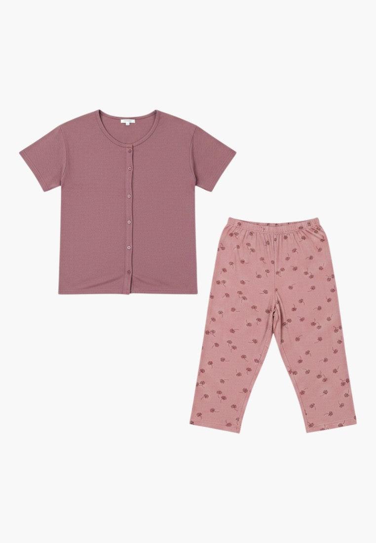 Falio plus size women's two-piece pajama set in mauve with a floral print on the capri pants. Features a short-sleeve button-up top and 3/4 length pants.