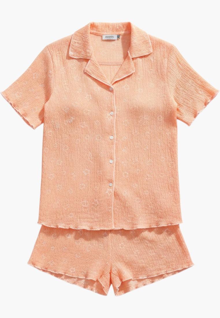 Falio women's peach short-sleeve pajama set with star pattern, V-neck, button-up top, and short bottoms. 100% cotton.