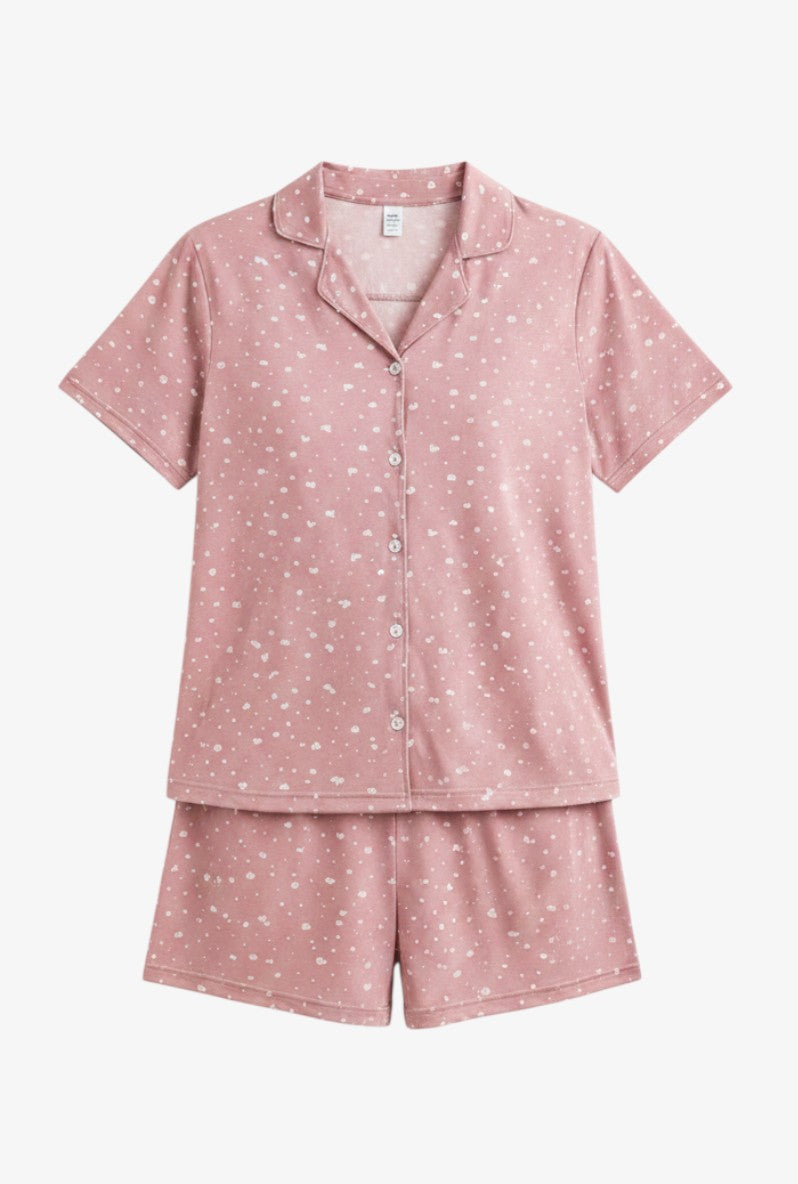 Falio women's pink cotton pajama set with short sleeves, button-down top, and shorts featuring a white heart pattern.