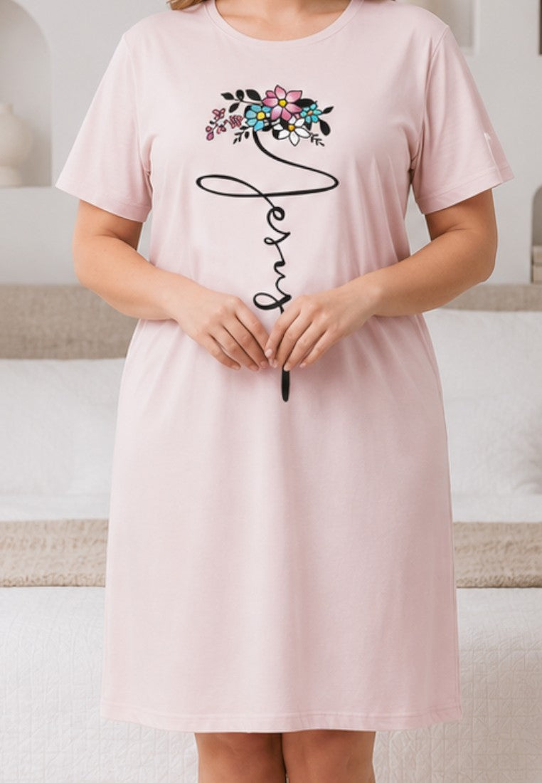 Falio light pink nightgown with short sleeves and a floral graphic print, worn by a woman in a bedroom.