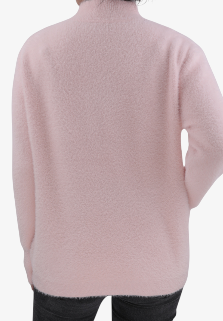 Back view of a Falio pink wool and cashmere blend sweater with a mock neck, worn with dark jeans.