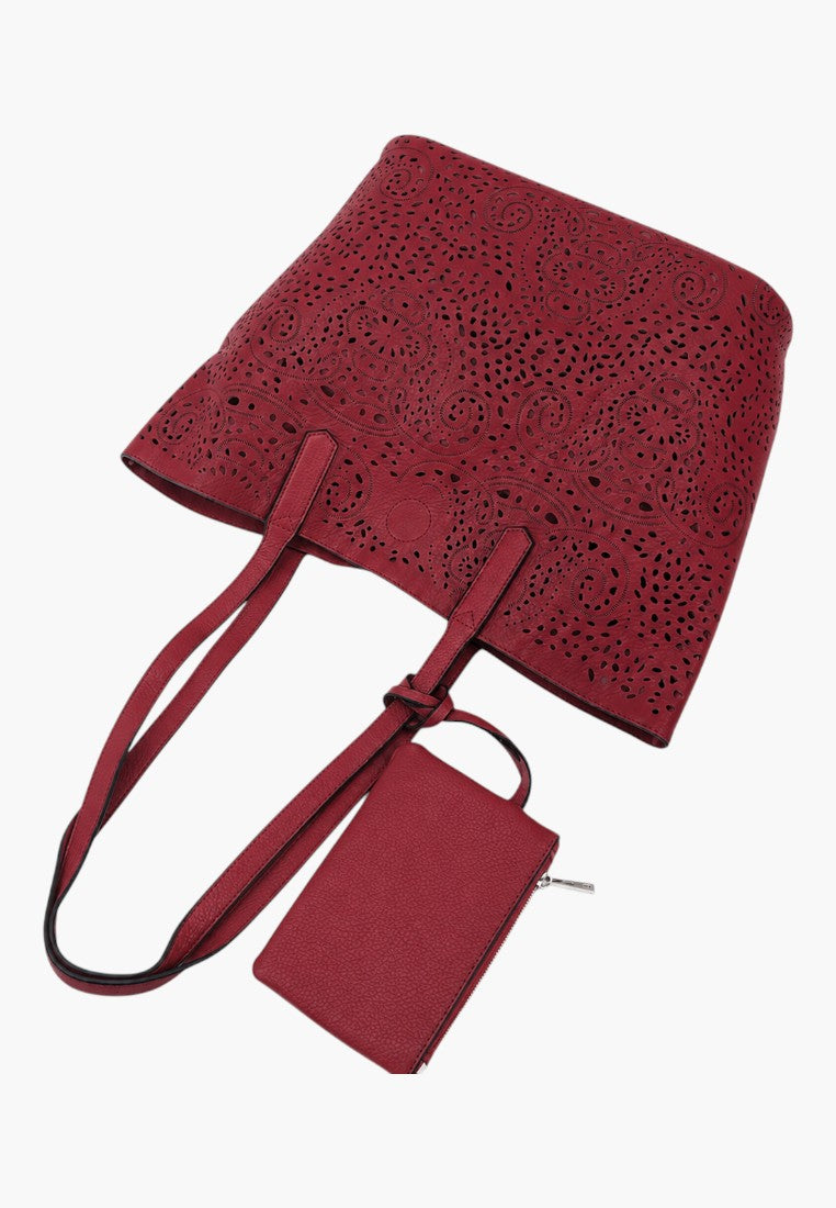Falio red faux leather shopper bag with intricate laser-cut floral patterns and a matching small zippered pouch.