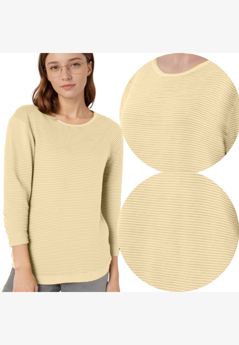 Falio women's ribbed cream sweater with a round neckline and long sleeves, worn by a model in a studio setting.