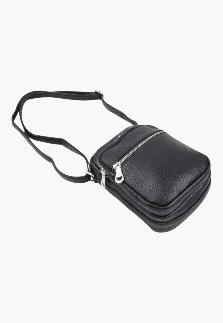 Falio small black faux leather crossbody bag with a zippered main compartment and adjustable shoulder strap.
