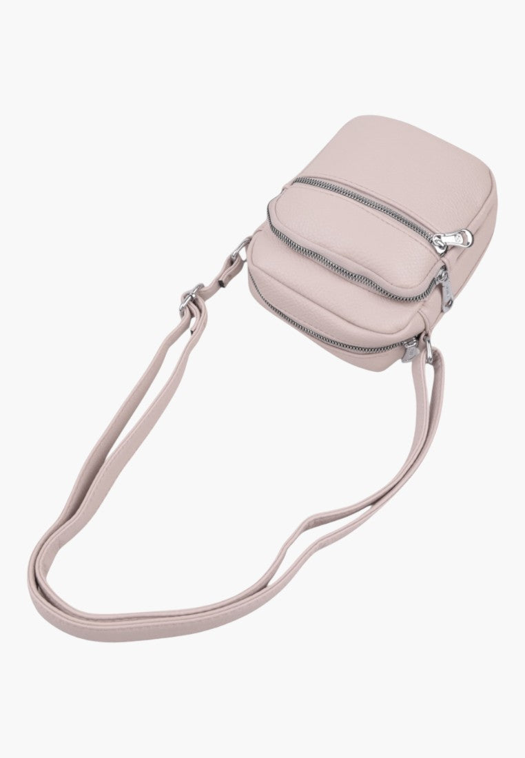 Falio small light pink faux leather crossbody bag with two front zippered pockets and an adjustable shoulder strap.