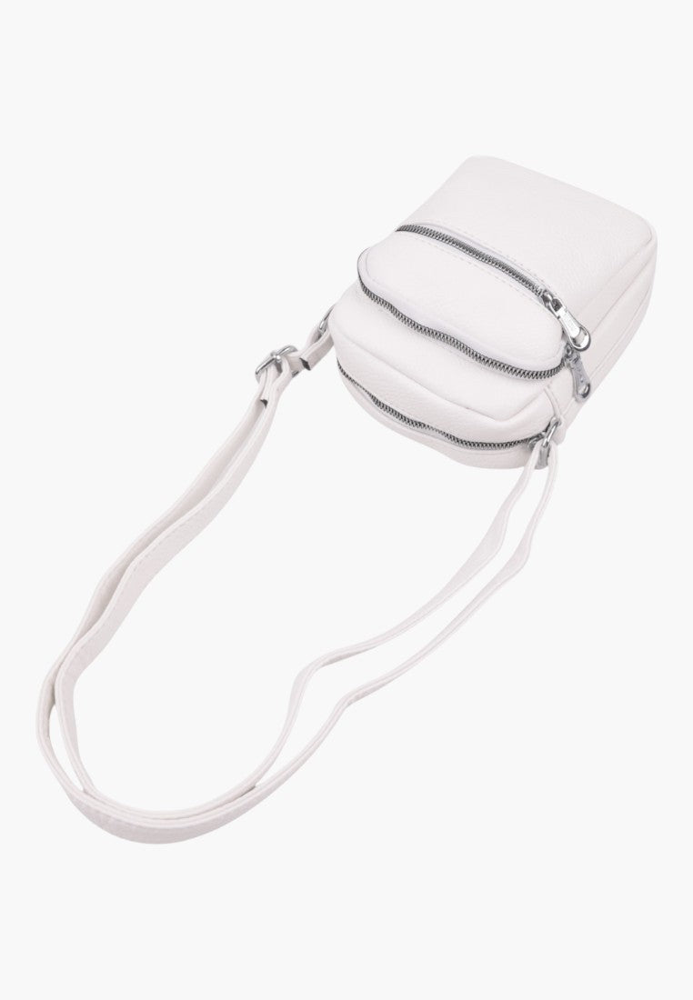 Falio small white faux leather crossbody bag with two zippered compartments and an adjustable shoulder strap
