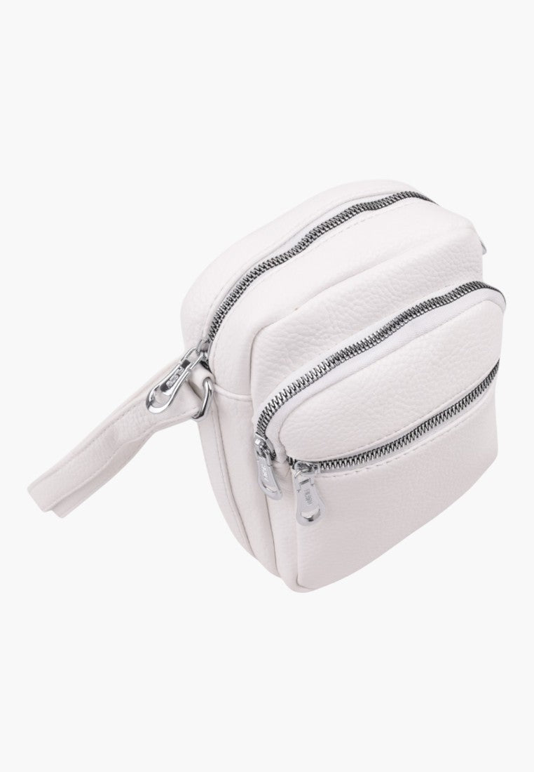 Falio small white faux leather crossbody bag with two zippered front compartments and a long shoulder strap