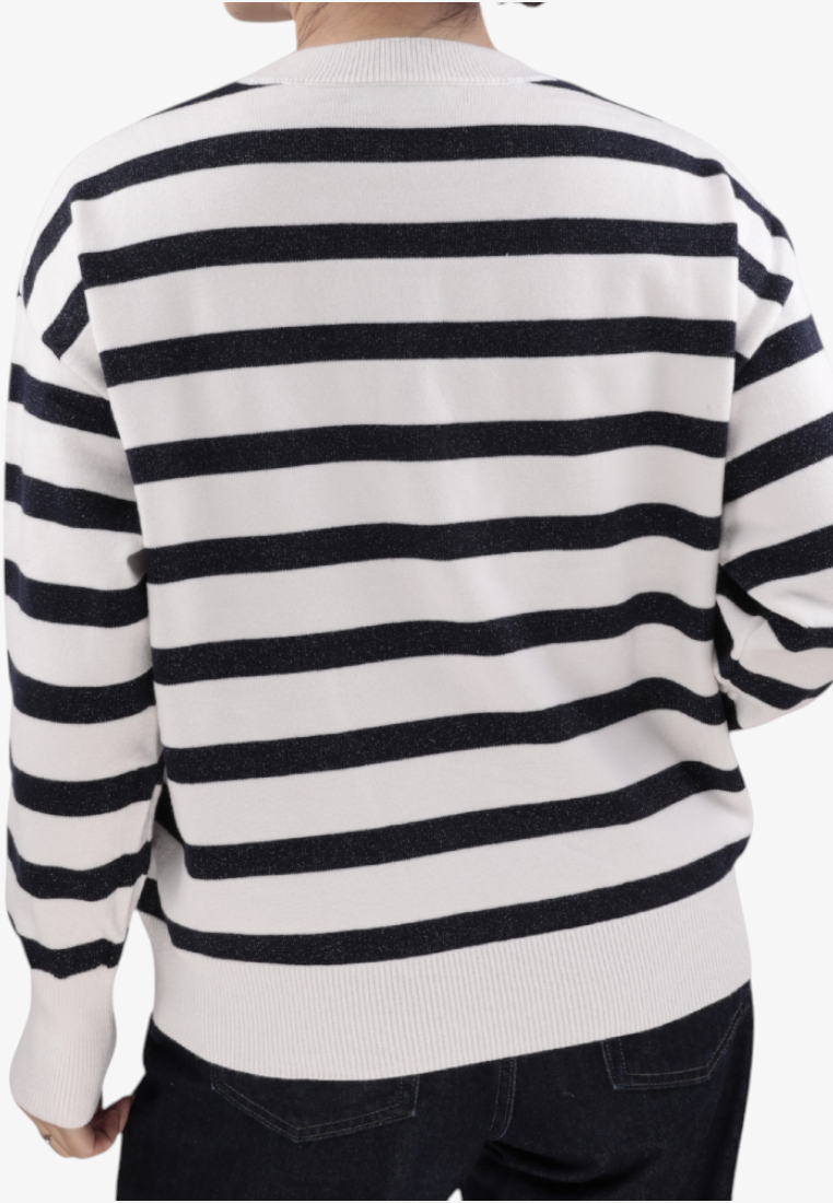 Falio women's white and black striped long-sleeve sweater with a round neckline, worn with dark jeans