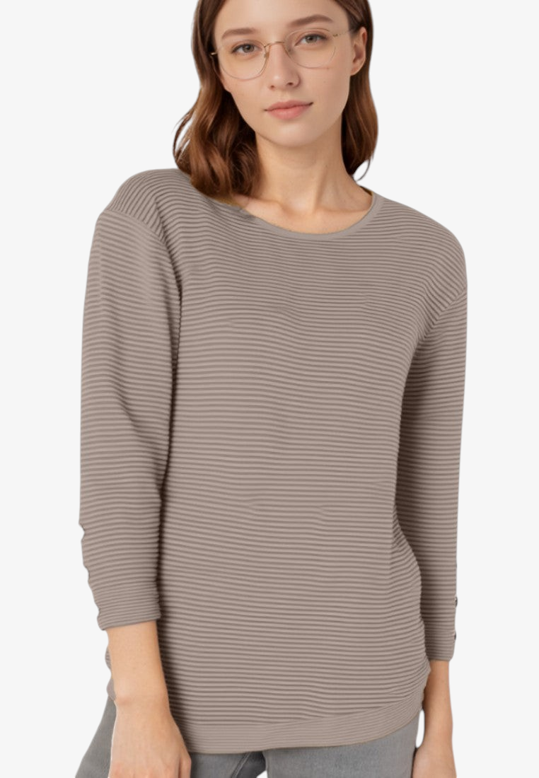 Falio women's long-sleeve ribbed sweater in taupe with a round neckline, worn by a model with glasses.
