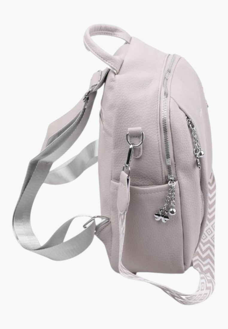 Falio urban women's backpack in light pink faux leather with A4 capacity, side pockets, and patterned straps.