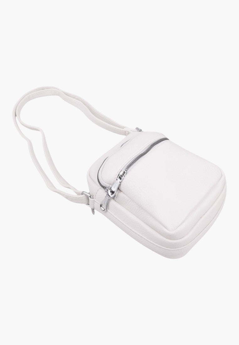 Falio small white faux leather crossbody bag with a zippered front pocket and long shoulder strap