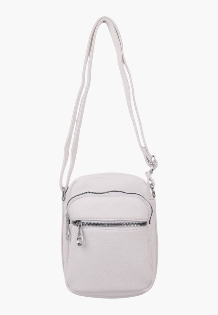 Falio small white faux leather crossbody bag with a zippered front pocket and adjustable shoulder strap