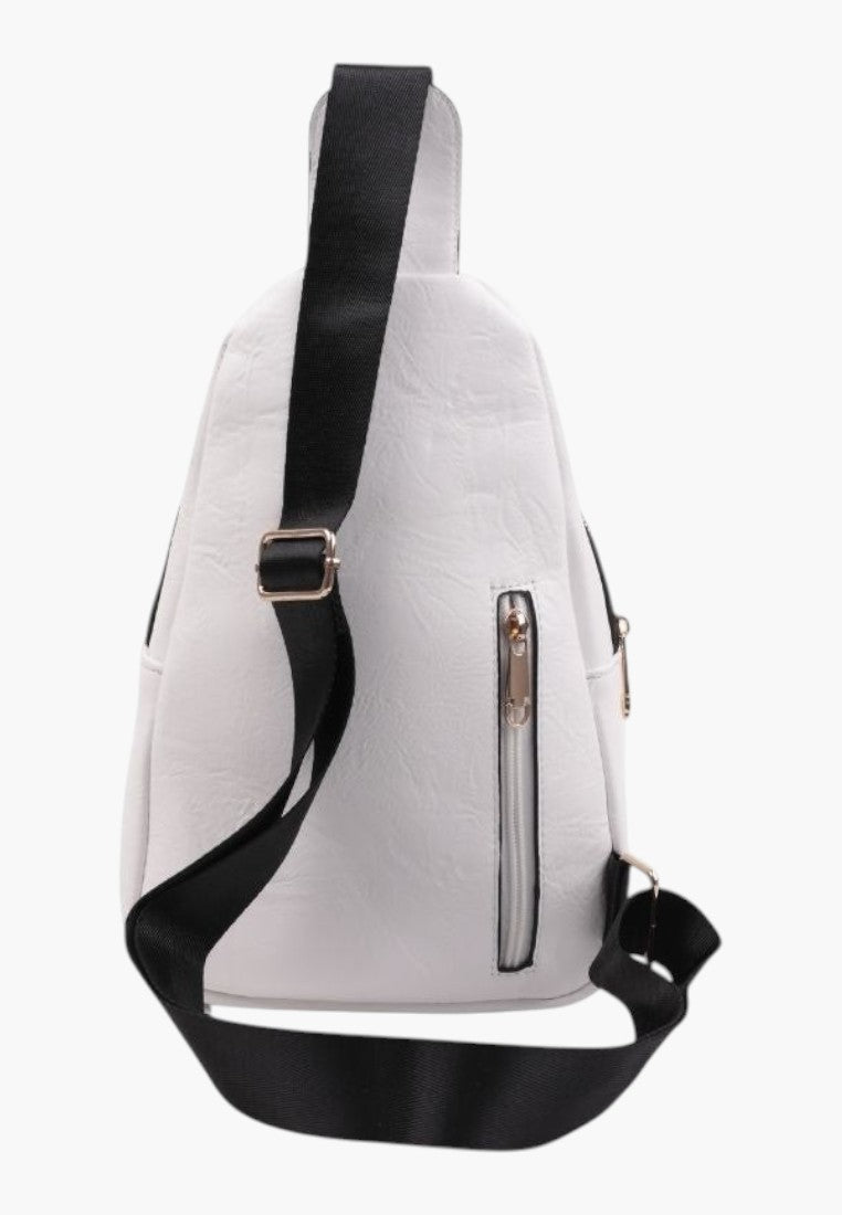 Falio white faux leather urban sling backpack with black adjustable strap and front zipper pocket