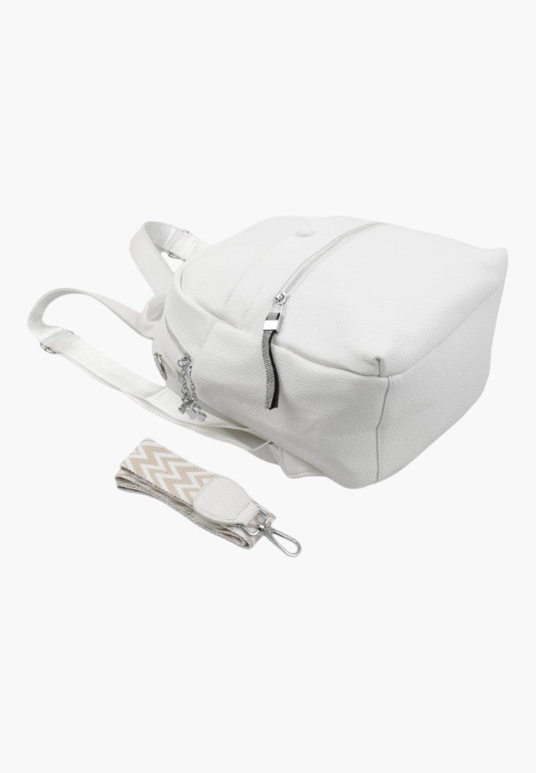 Falio white faux leather urban backpack with a detachable patterned strap and multiple zippered compartments.