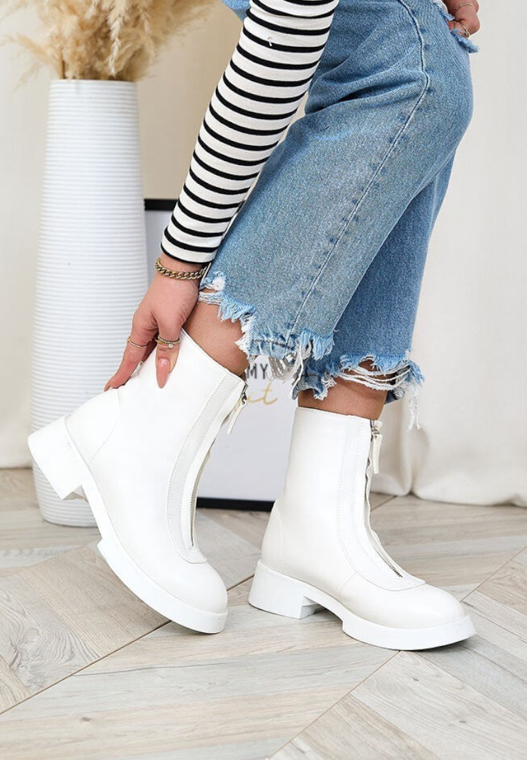 Falio white insulated ankle boots made of eco-leather with a front zipper, worn with blue jeans