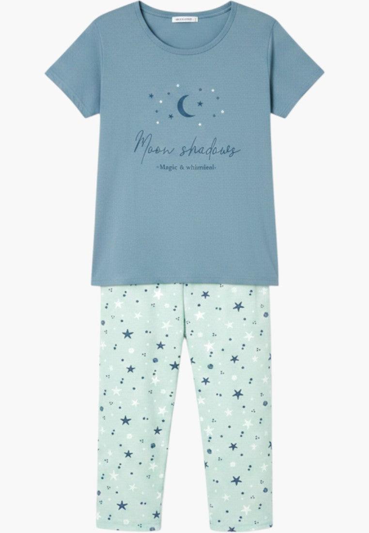 Falio women's blue t-shirt with moon and stars graphic and mint green capri pajama pants with star print.