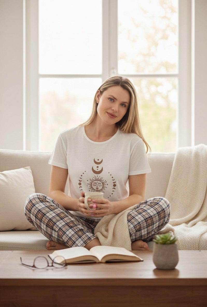 Falio women's white cotton pajama set with short sleeves and 3/4 pants featuring a celestial sun and moon graphic.